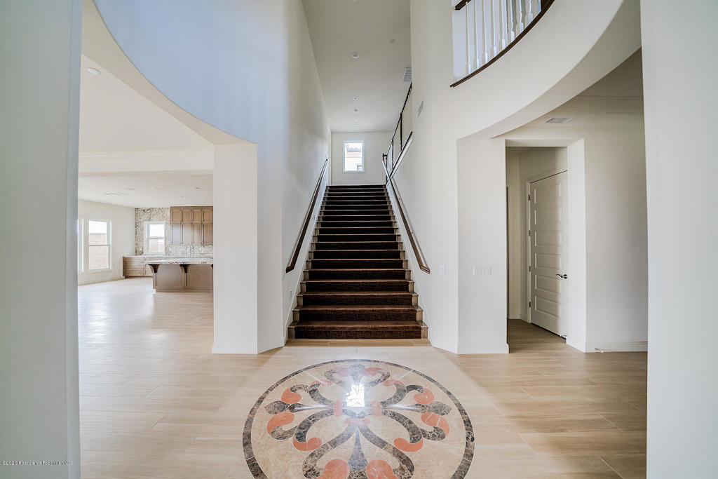 20156 West Cromwell Way Porter Ranch, CA 91326 - Photo 2 of 39 a view of a hallway with wooden floor and staircase