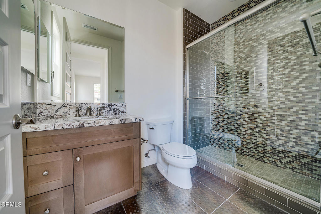 20156 West Cromwell Way Porter Ranch, CA 91326 - Photo 28 of 39 a bathroom with a granite countertop sink a toilet and a mirror