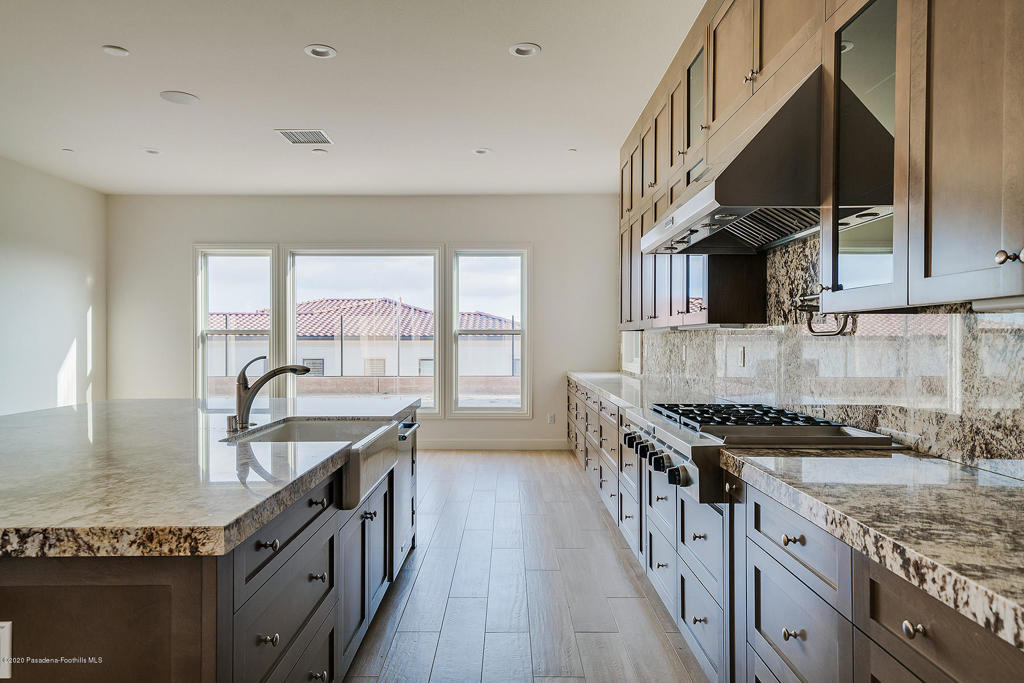 20156 West Cromwell Way Porter Ranch, CA 91326 - Photo 8 of 39 a kitchen with granite countertop a sink a counter space appliances and cabinets