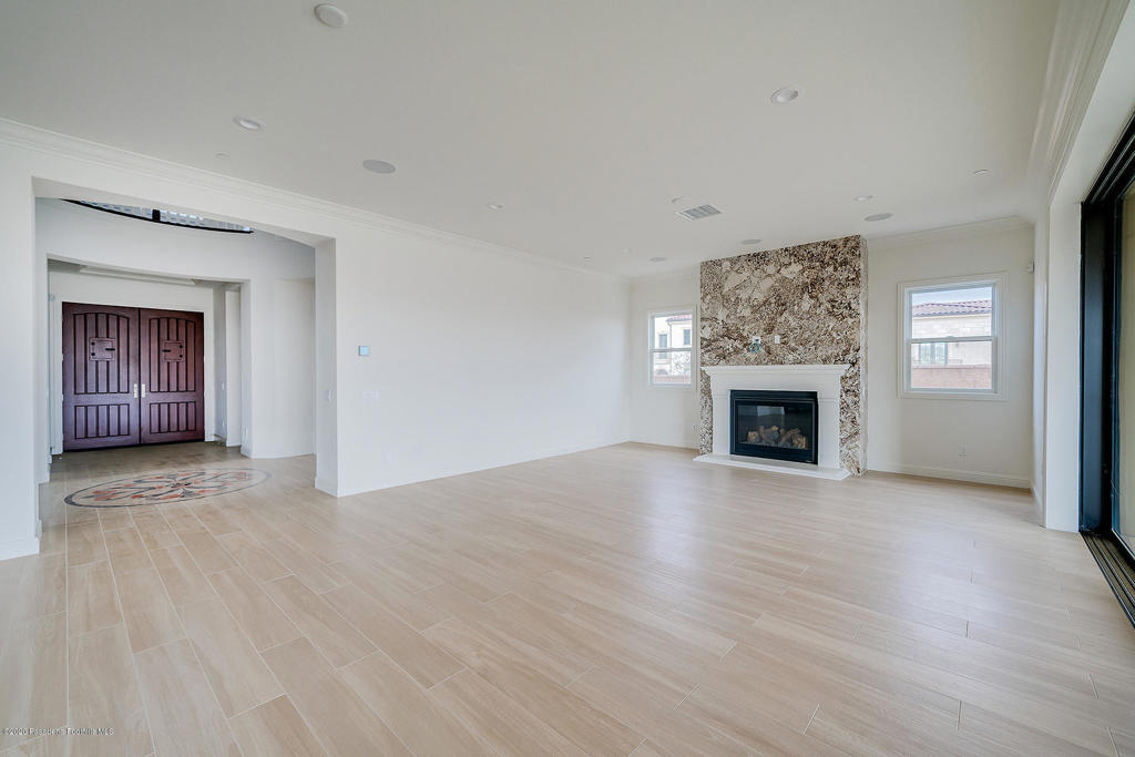 20156 West Cromwell Way Porter Ranch, CA 91326 - Photo 9 of 39 an empty room with wooden floor fireplace and windows