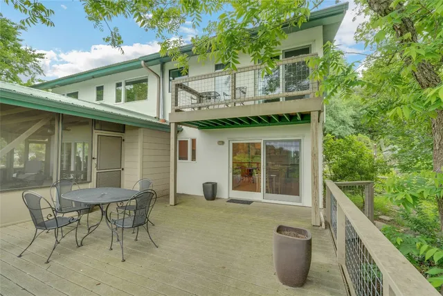 a view of a chair and table in backyard of the house