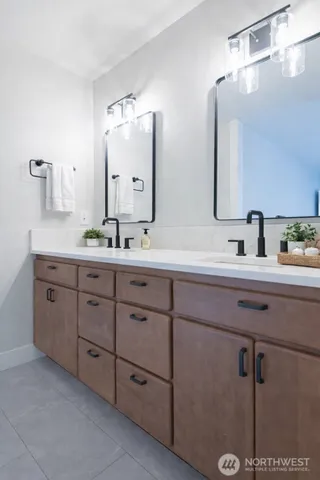 a bathroom with a double vanity sink and mirror