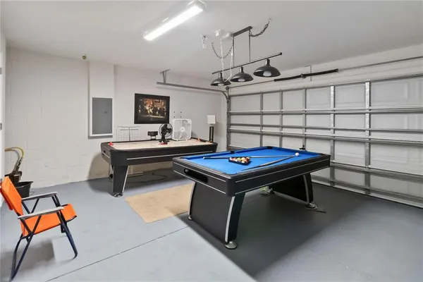 a living room with pool table and windows