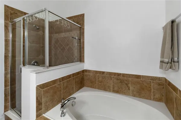 a bathroom with a tub and a shower