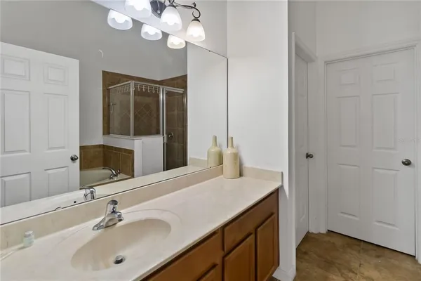 a bathroom with a sink a vanity and a mirror