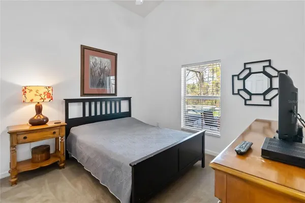 a bedroom with a bed and window