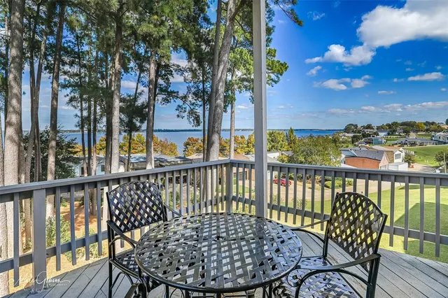 a view of a dining room with furniture a chandelier and wooden floor