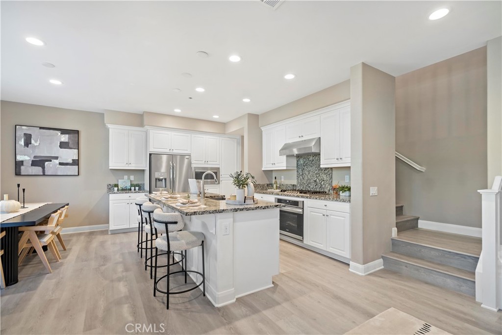 7459 Solstice Place Rancho Cucamonga, CA 91739 - Photo 15 of 57 a kitchen with a table and chairs in it