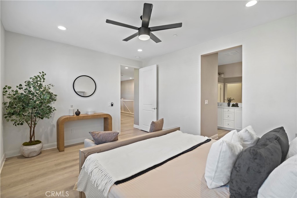 7459 Solstice Place Rancho Cucamonga, CA 91739 - Photo 30 of 57 a bedroom with a bed and a chandelier