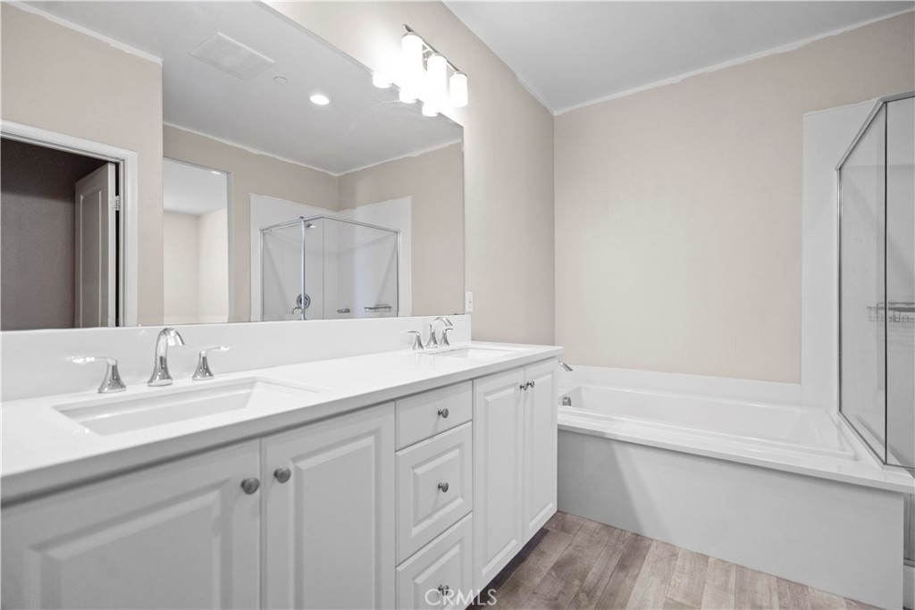 7459 Solstice Place Rancho Cucamonga, CA 91739 - Photo 48 of 57 a bathroom with a sink double vanity granite tub and a mirror