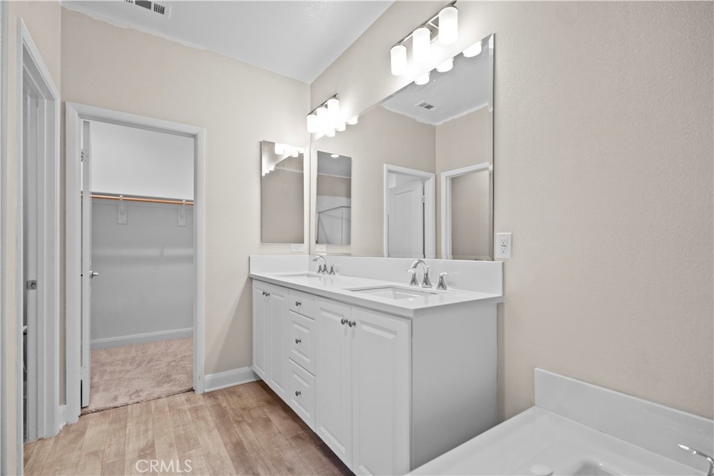 7459 Solstice Place Rancho Cucamonga, CA 91739 - Photo 50 of 57 a bathroom with a double vanity sink and mirror