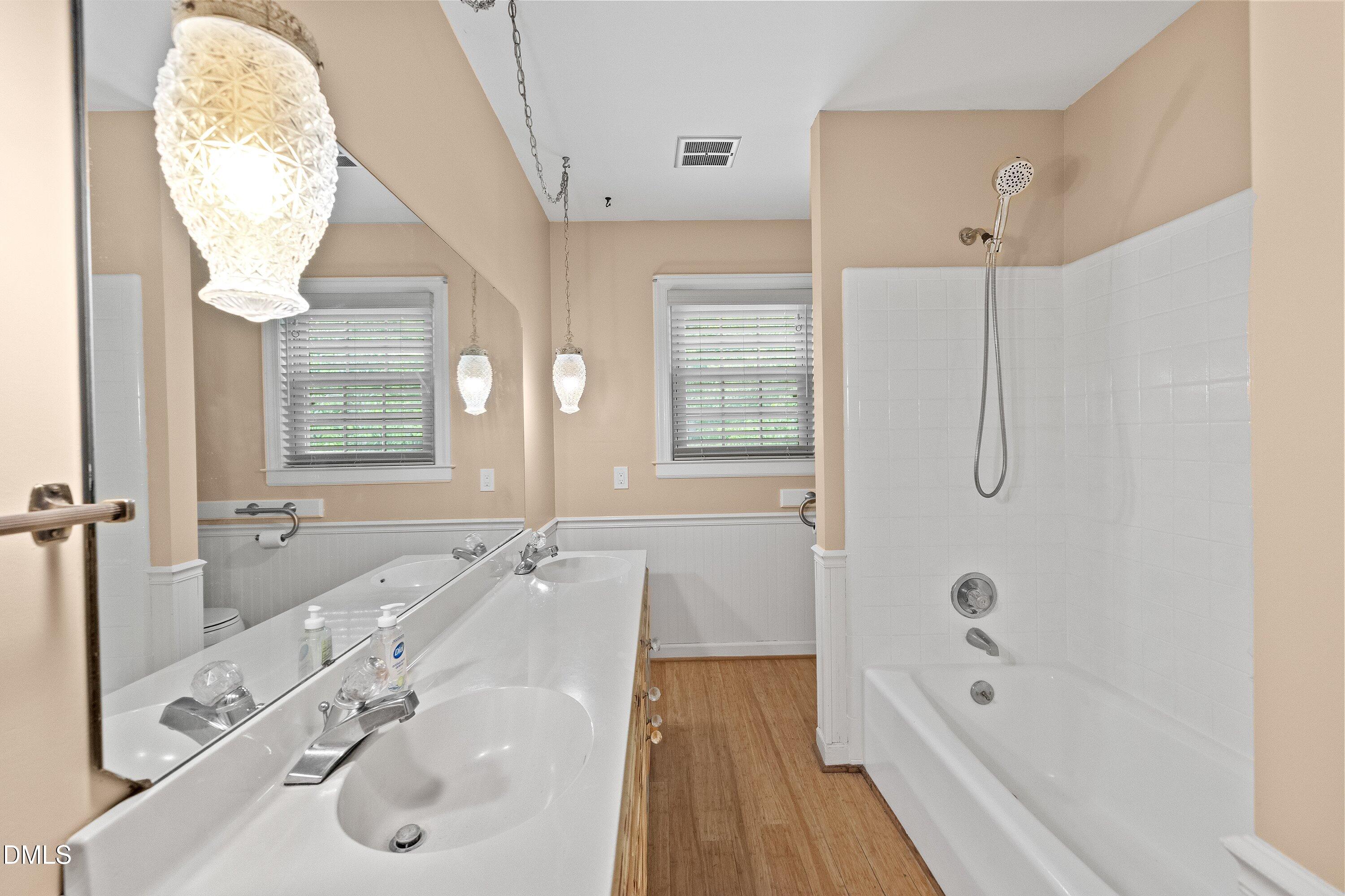 8133 Holly Forest Road Wake Forest, NC 27587 - Photo 36 of 50 a bathroom with a tub sink and mirror