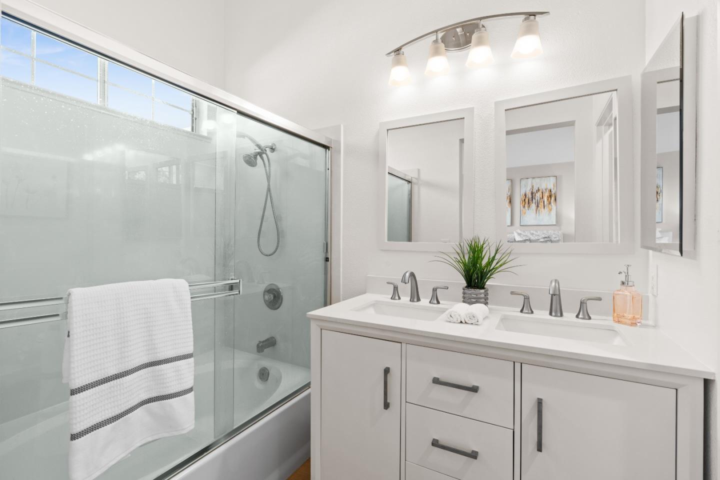 258 Trenton Circle Pleasanton, CA 94566 - Photo 6 of 10 a bathroom with a shower sink vanity and mirror