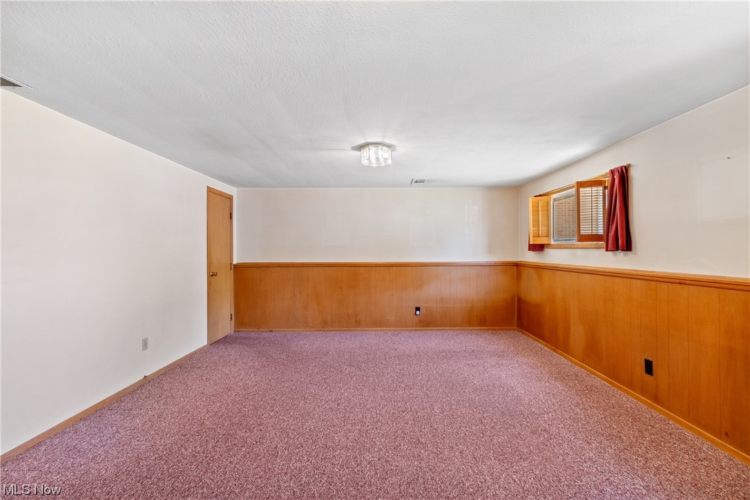 1722 Chelmsford Road Cleveland, OH 44124 - Photo 11 of 34 Unfurnished room featuring light carpet and a textured ceiling