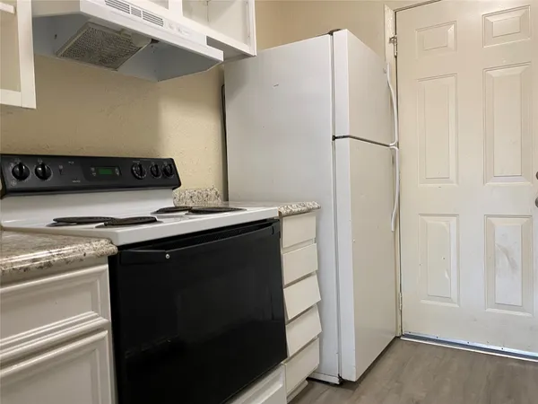 a kitchen with a stove and a refrigerator