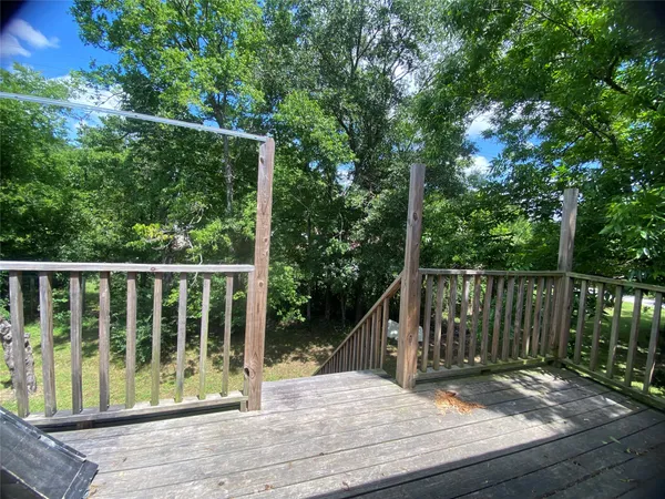 a view of balcony with wooden floor and fence
