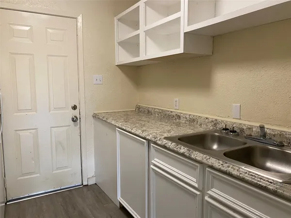 a kitchen with a refrigerator and a stove