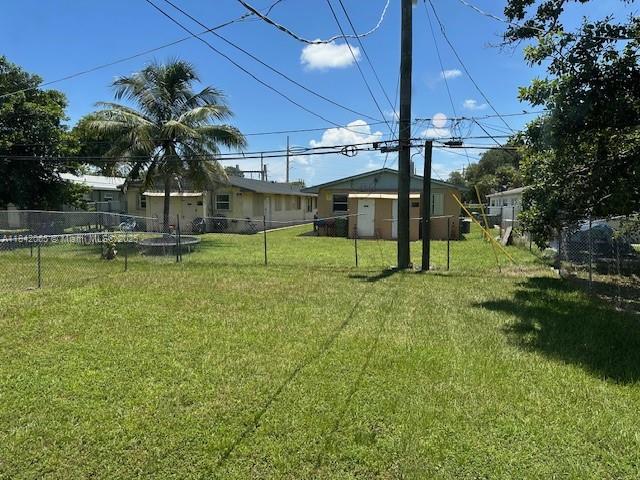 851 Southwest 9th Street, Unit 2 Hallandale Beach, FL 33009 - Photo 2 of 9 a view of a house with a yard