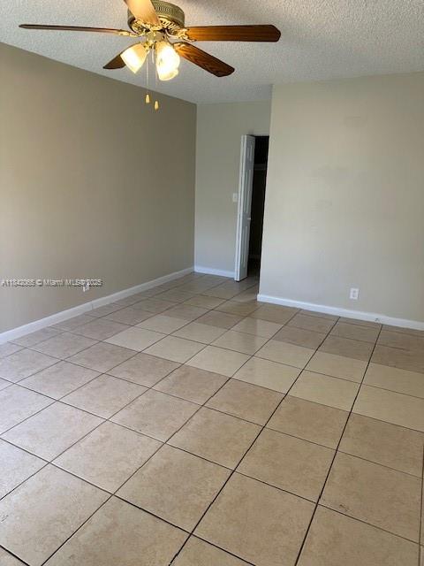 851 Southwest 9th Street, Unit 2 Hallandale Beach, FL 33009 - Photo 5 of 9 a view of an empty room with a chandelier fan