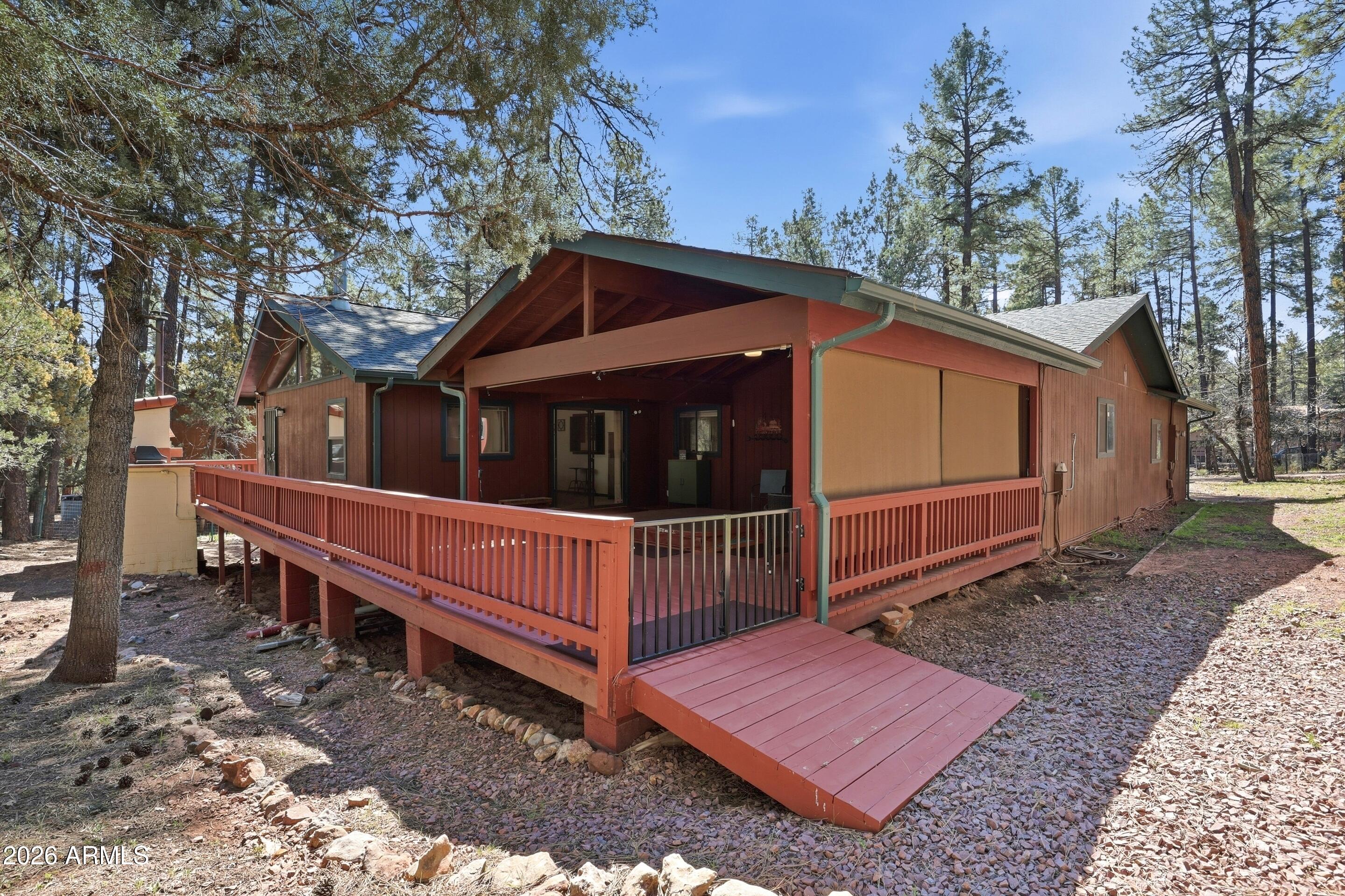 6740 Ridge Road Pine, AZ 85544 - Photo 28 of 35 a view of a house with a yard and wooden fence