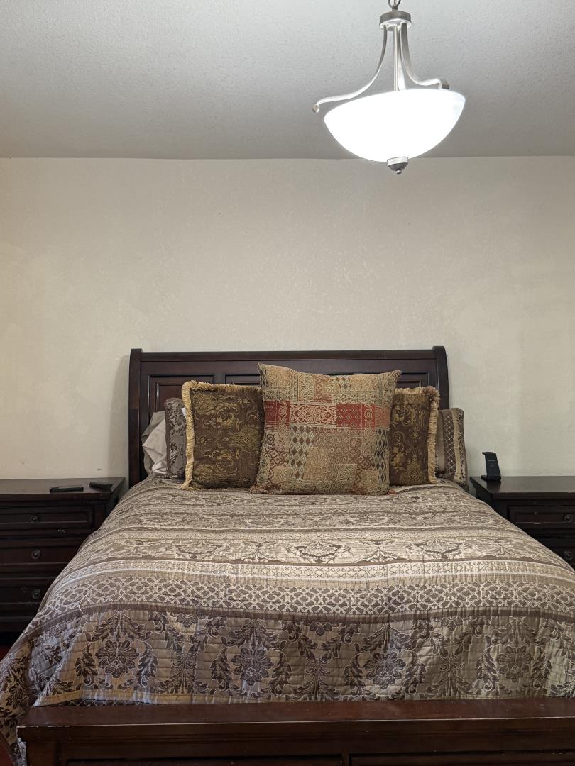 5736 Silver Leaf Road San Jose, CA 95138 - Photo 28 of 42 a bedroom with a bed and a lamp