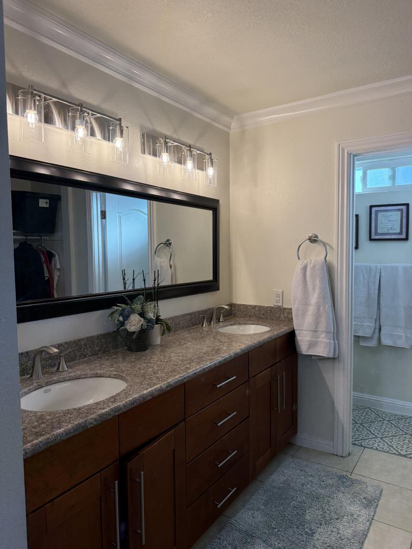 5736 Silver Leaf Road San Jose, CA 95138 - Photo 29 of 42 a bathroom with a granite countertop double vanity sink and mirror