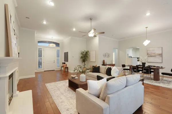 an empty room with a window and a ceiling fan