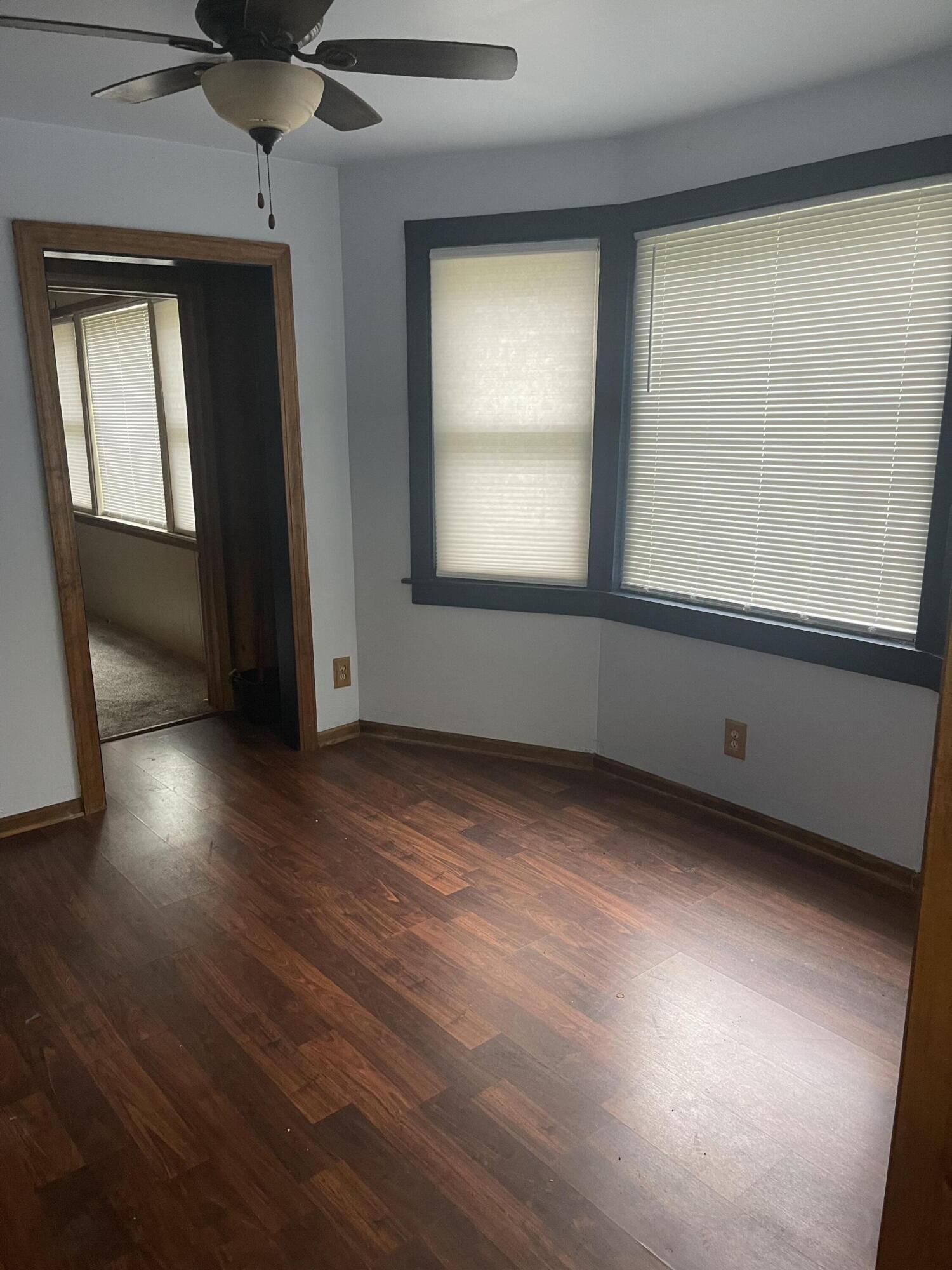 3125 West Ridge Road Gary, IN 46408 - Photo 8 of 36 an empty room with wooden floor and windows