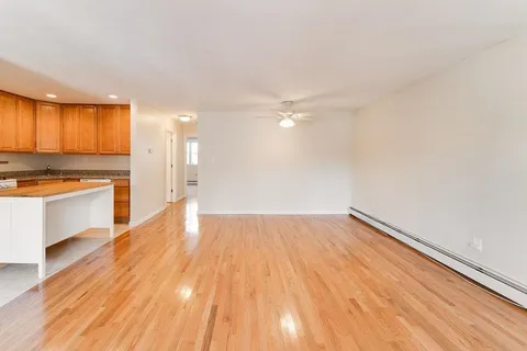 a view of kitchen with stove and wooden floor