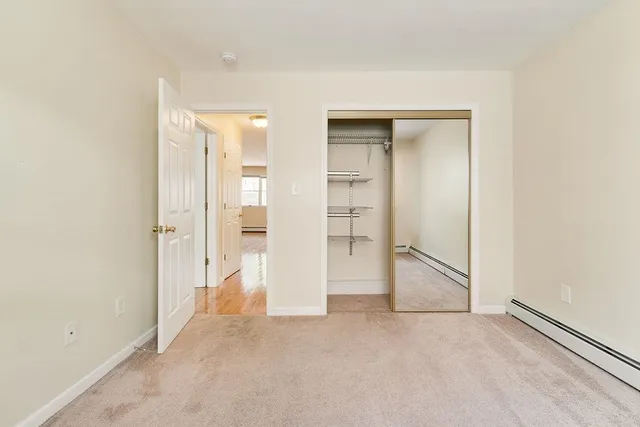 an empty room with a bathroom and a sink