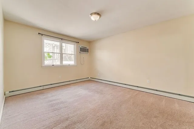 an empty room with a empty space and a window