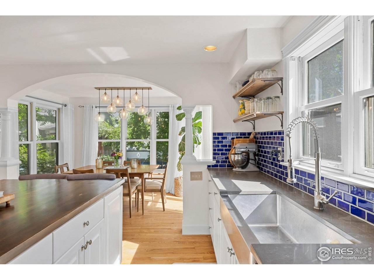 1133 Mapleton Avenue Boulder, CO 80304 - Photo 12 of 40 a living room with furniture a flat screen tv and a large window