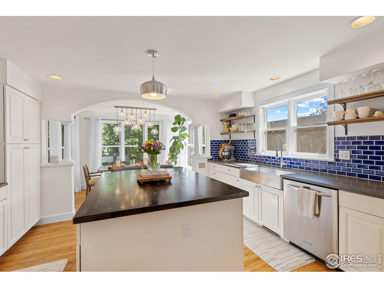 1133 Mapleton Avenue Boulder, CO 80304 - Photo 14 of 40 a kitchen with kitchen island a large counter top space and stainless steel appliances