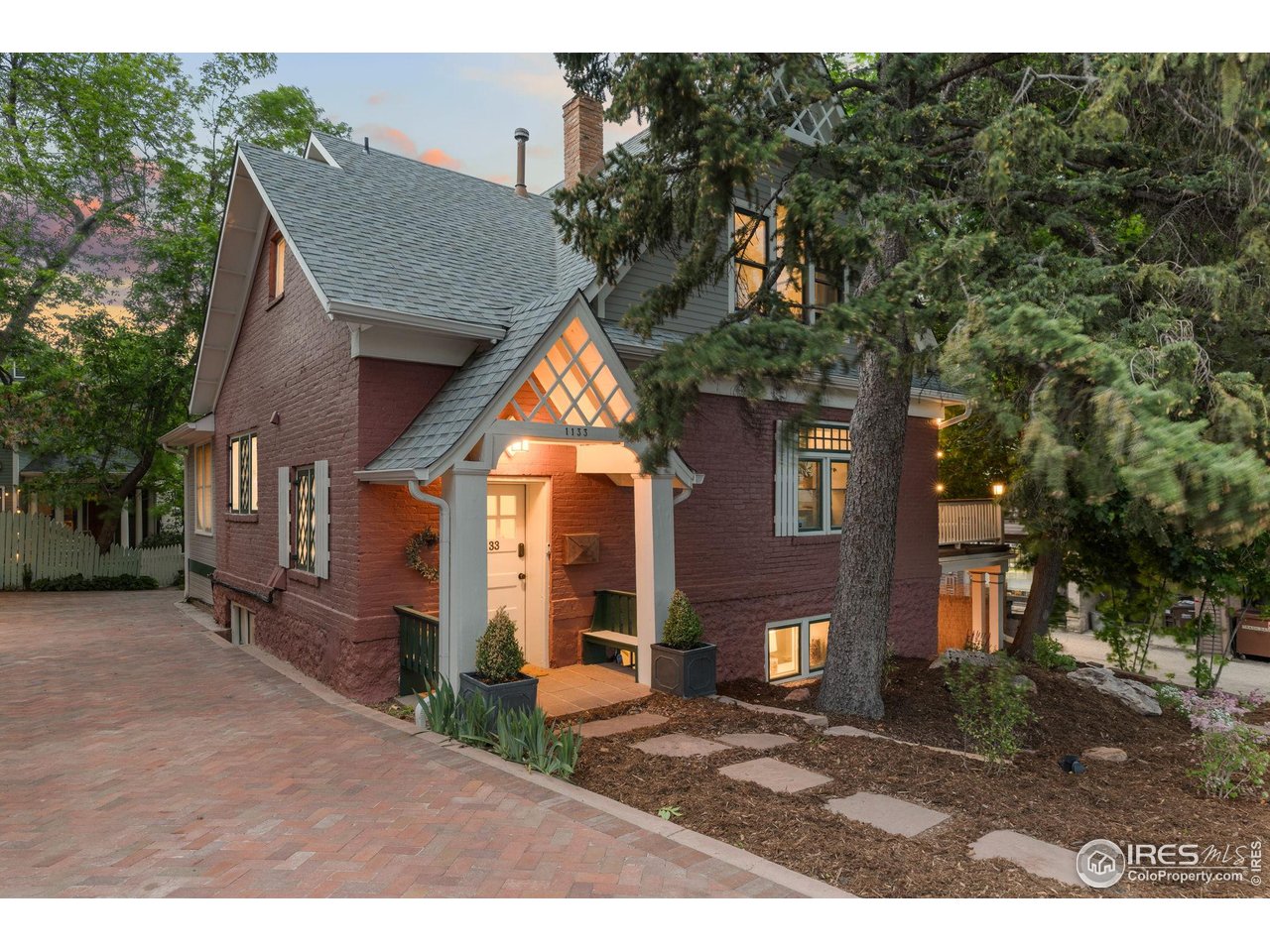 1133 Mapleton Avenue Boulder, CO 80304 - Photo 3 of 40 a front view of a house with a yard and garage