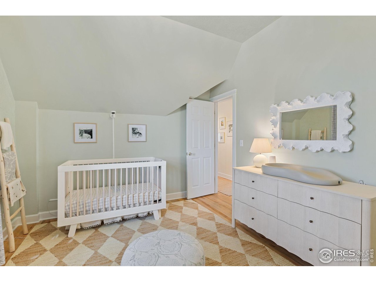1133 Mapleton Avenue Boulder, CO 80304 - Photo 32 of 40 a bedroom with a bed and a mirror on dresser