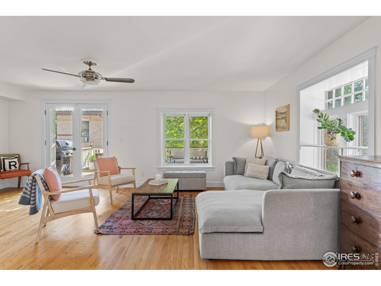 1133 Mapleton Avenue Boulder, CO 80304 - Photo 8 of 40 a living room with furniture a large window and a chandelier