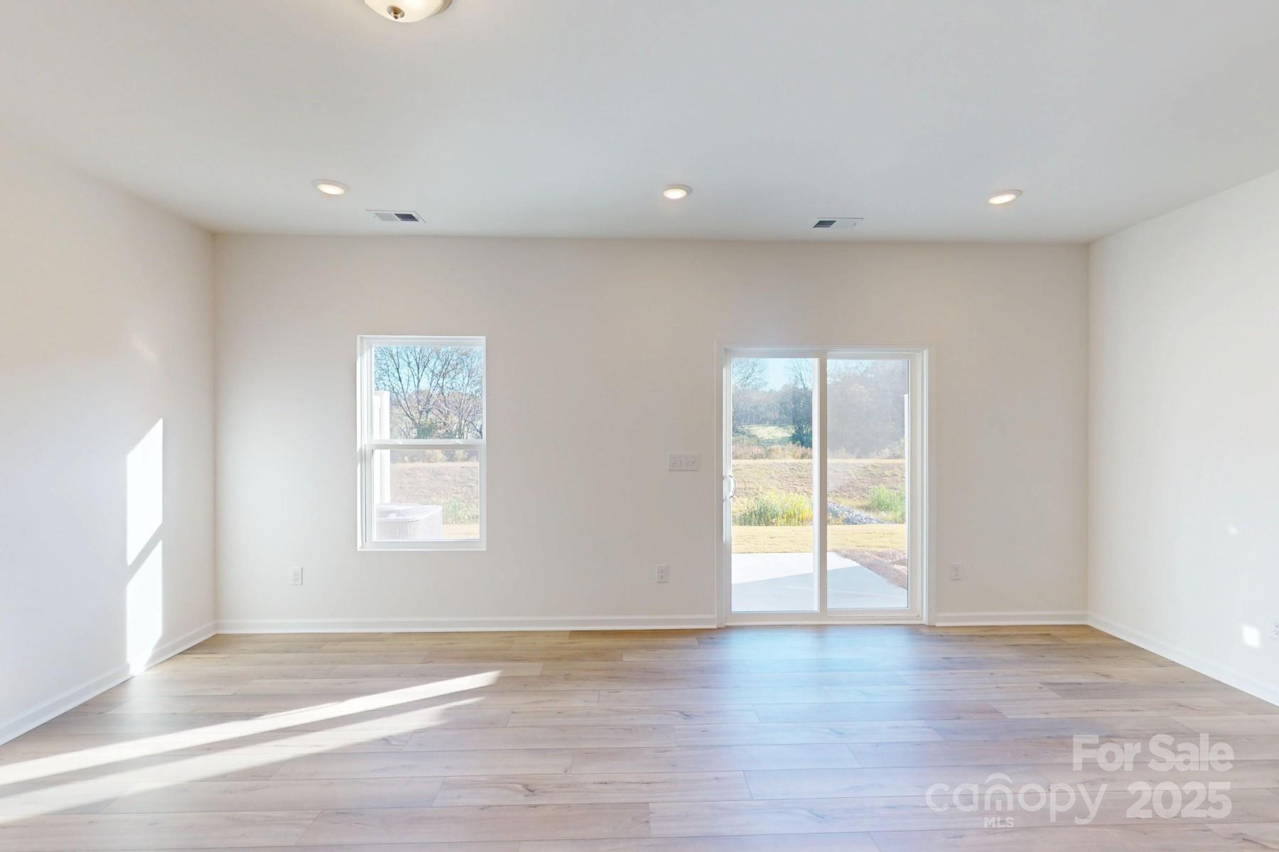 1129 Overbrook Place Wingate, NC 28174 - Photo 11 of 21 a view of an empty room with wooden floor and a window