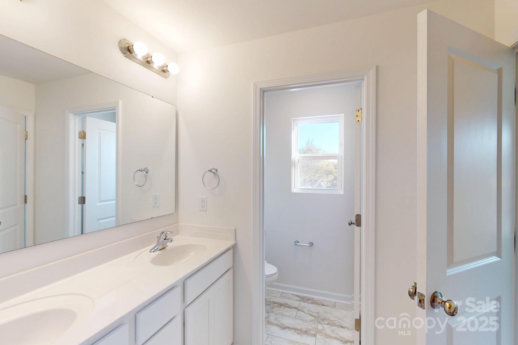 1129 Overbrook Place Wingate, NC 28174 - Photo 20 of 21 a bathroom with a granite countertop sink and a mirror