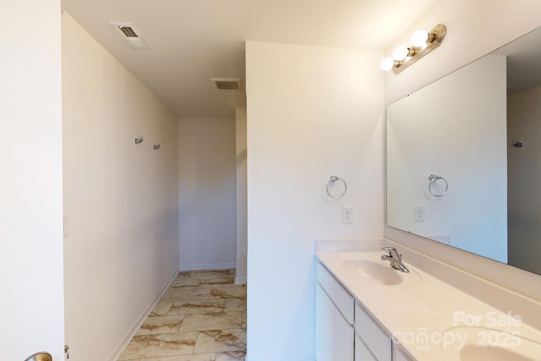 1129 Overbrook Place Wingate, NC 28174 - Photo 21 of 21 a bathroom with a granite countertop sink and a mirror
