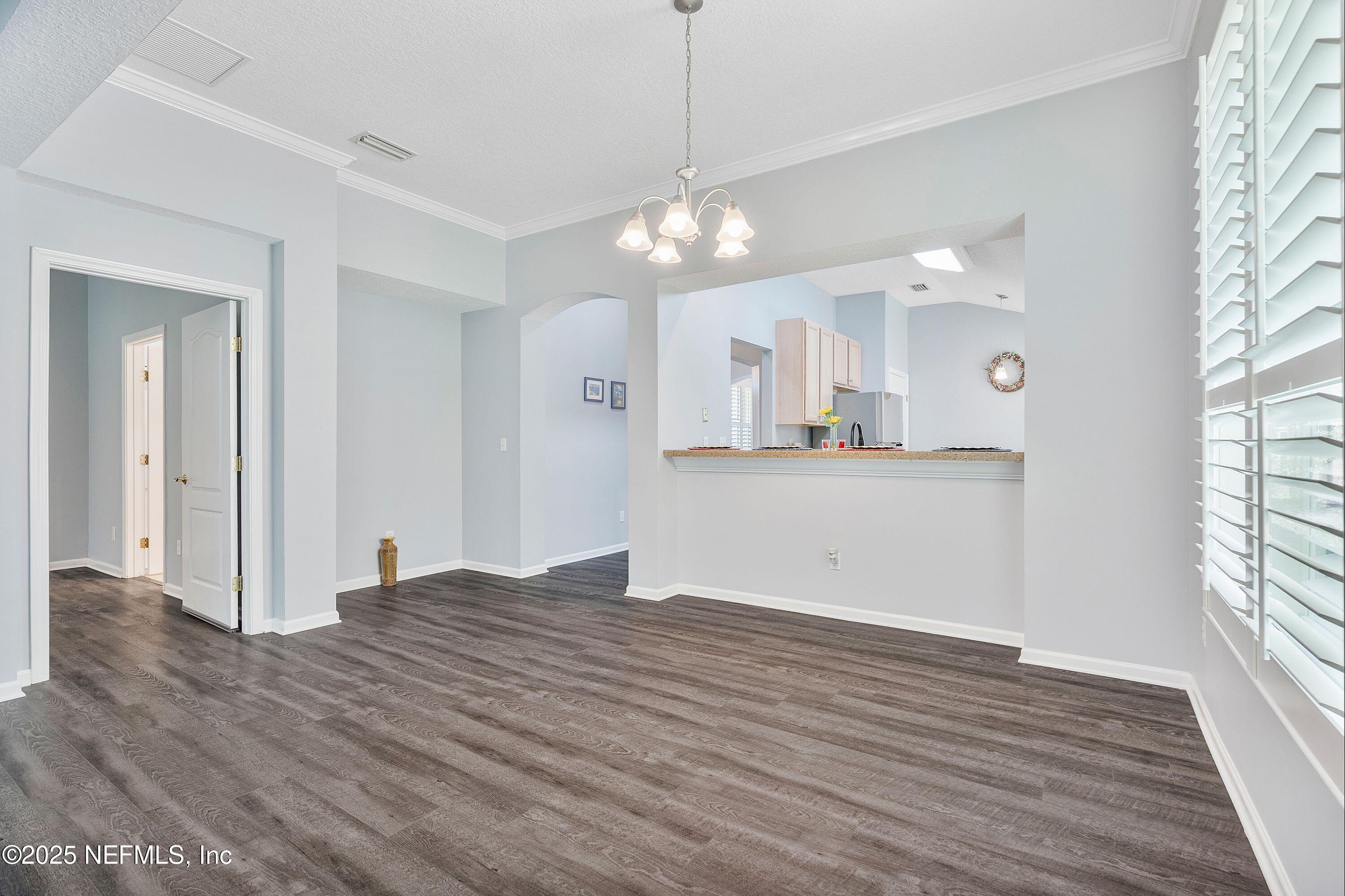 2120 Stone Creek Drive, Unit E Fleming Island, FL 32003 - Photo 11 of 66 a view of a kitchen with wooden floor and a kitchen