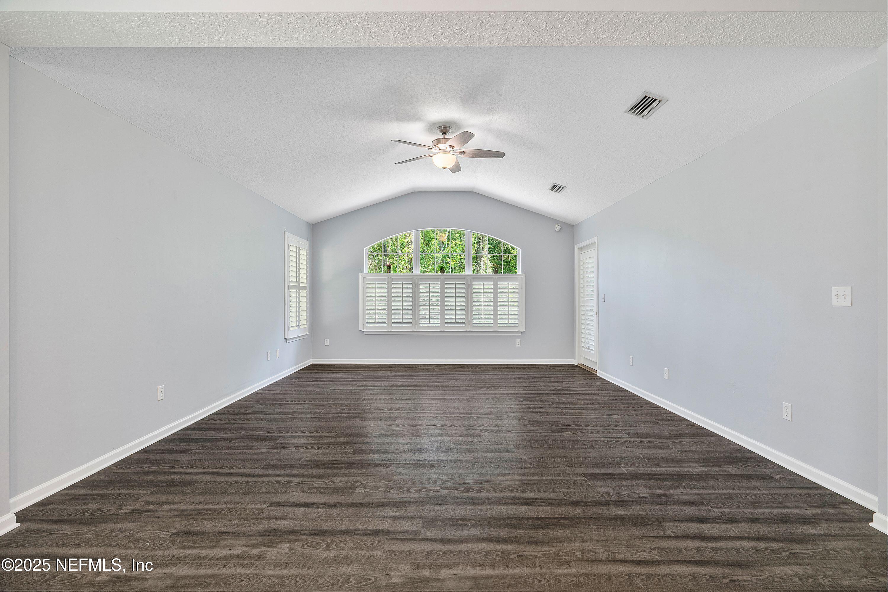 2120 Stone Creek Drive, Unit E Fleming Island, FL 32003 - Photo 13 of 66 wooden floor in an empty room with a window
