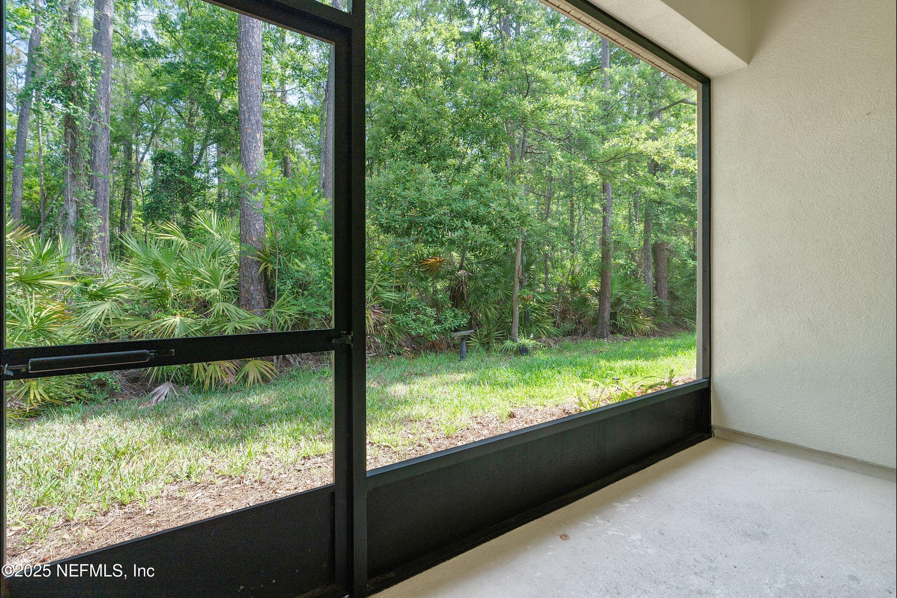 2120 Stone Creek Drive, Unit E Fleming Island, FL 32003 - Photo 18 of 66 a view of lot of green trees from a window