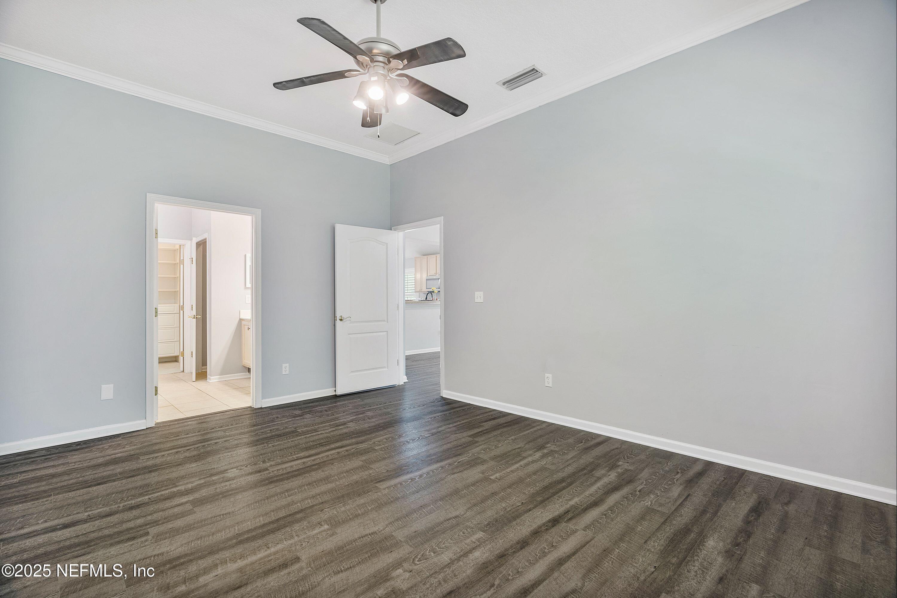 2120 Stone Creek Drive, Unit E Fleming Island, FL 32003 - Photo 20 of 66 an empty room with wooden floor and windows