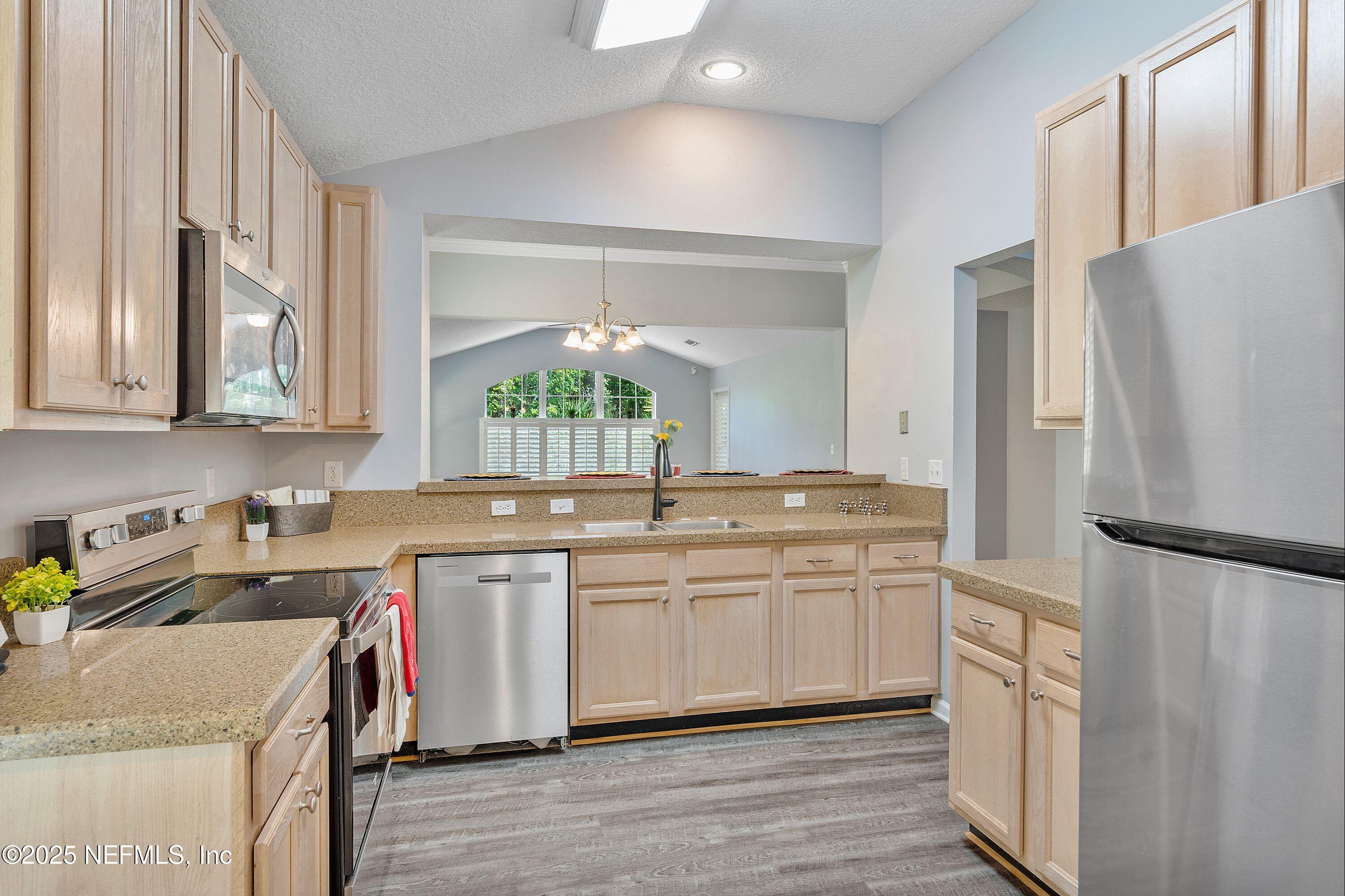 2120 Stone Creek Drive, Unit E Fleming Island, FL 32003 - Photo 2 of 66 a kitchen with stainless steel appliances granite countertop a sink stove and refrigerator