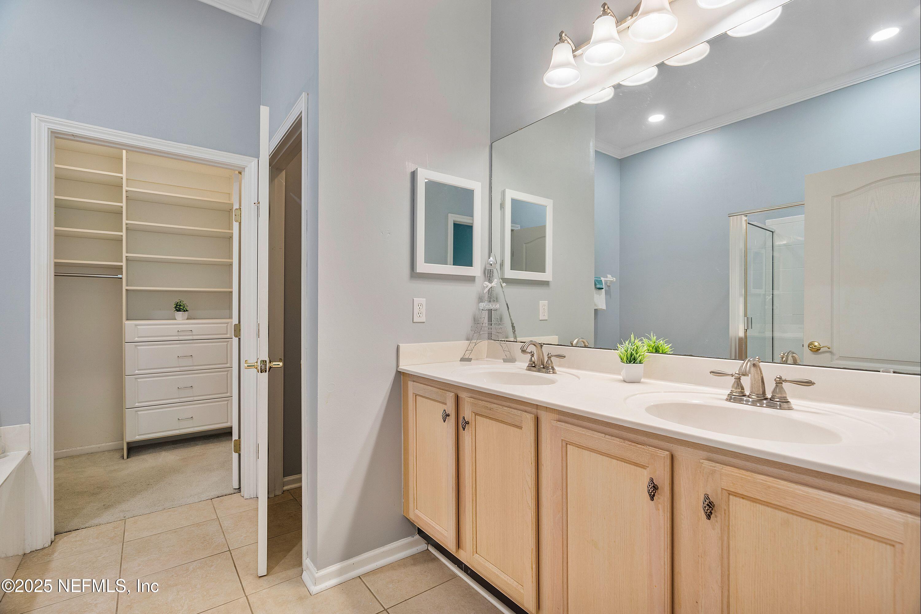 2120 Stone Creek Drive, Unit E Fleming Island, FL 32003 - Photo 21 of 66 a bathroom with a sink vanity and a mirror