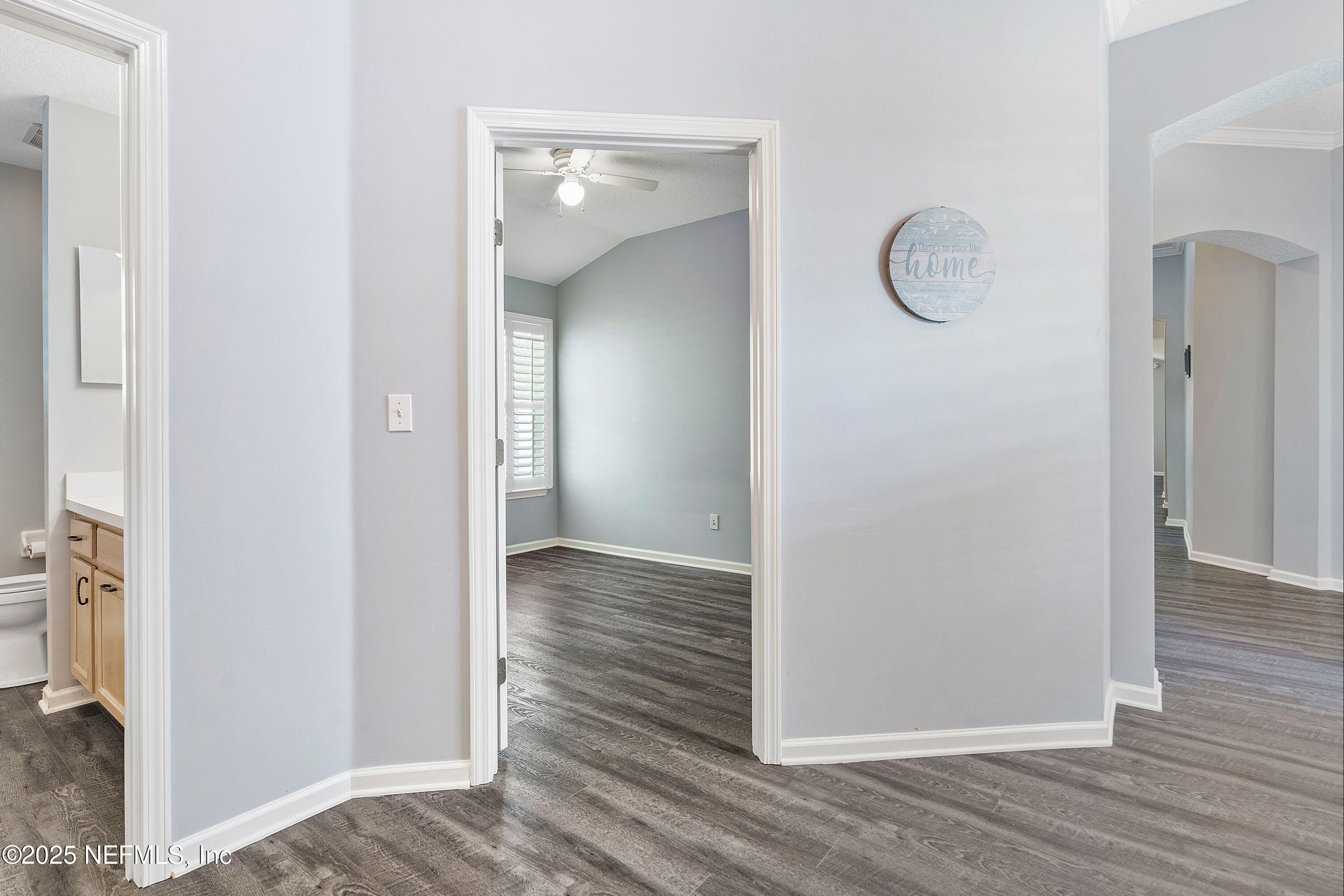 2120 Stone Creek Drive, Unit E Fleming Island, FL 32003 - Photo 24 of 66 an empty room with wooden floor and mirror