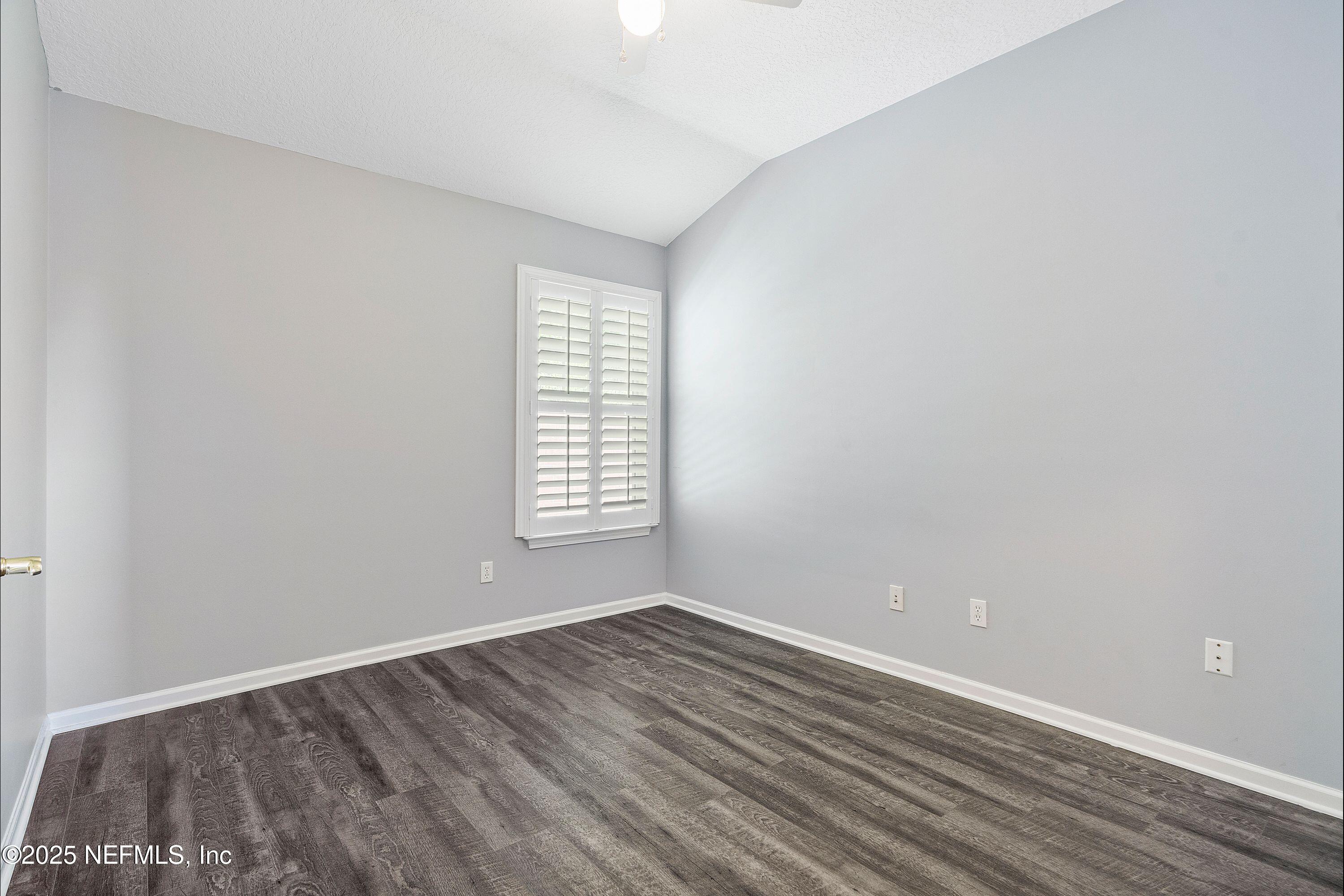 2120 Stone Creek Drive, Unit E Fleming Island, FL 32003 - Photo 26 of 66 wooden floor in an empty room with a window