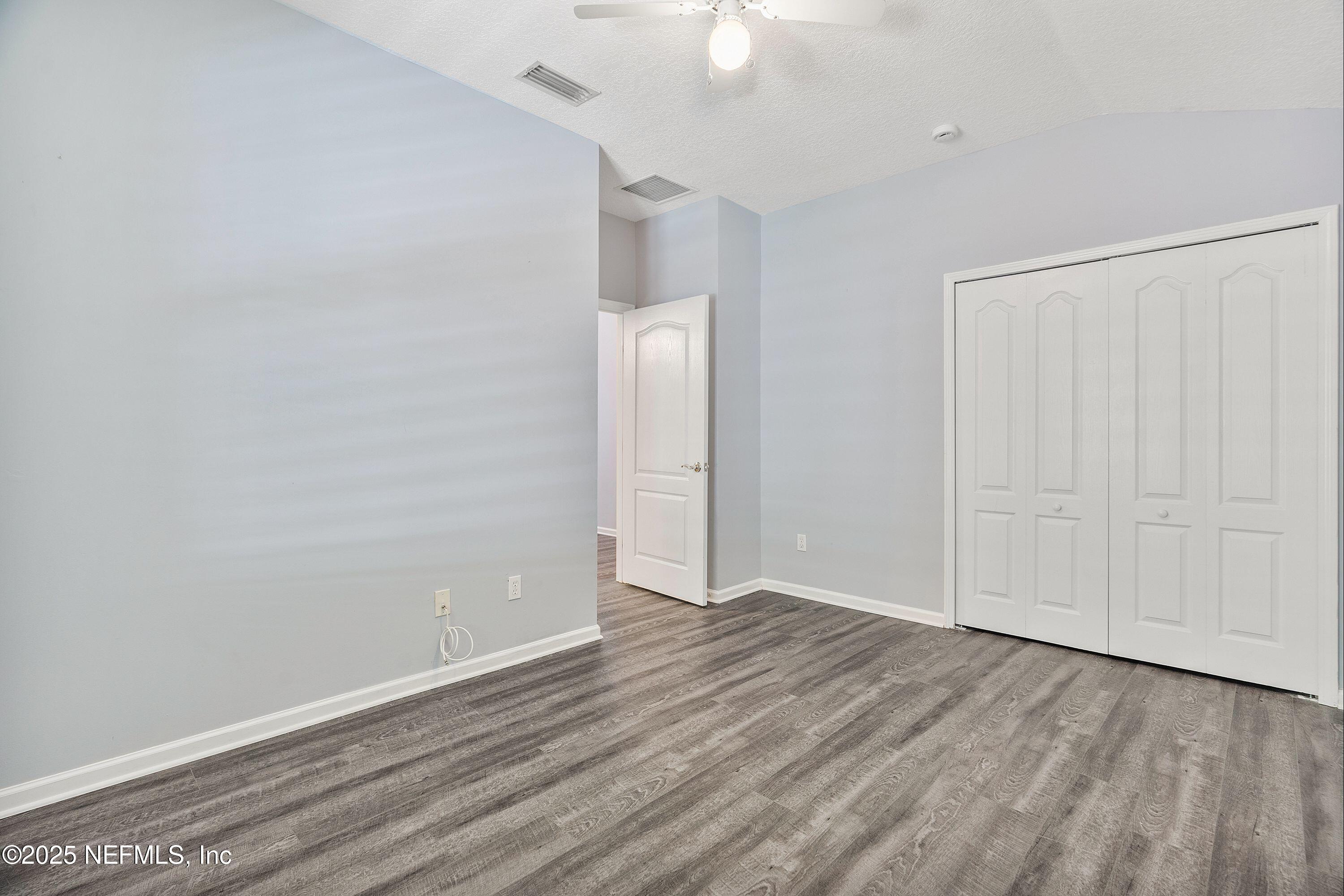 2120 Stone Creek Drive, Unit E Fleming Island, FL 32003 - Photo 29 of 66 wooden floor in an empty room