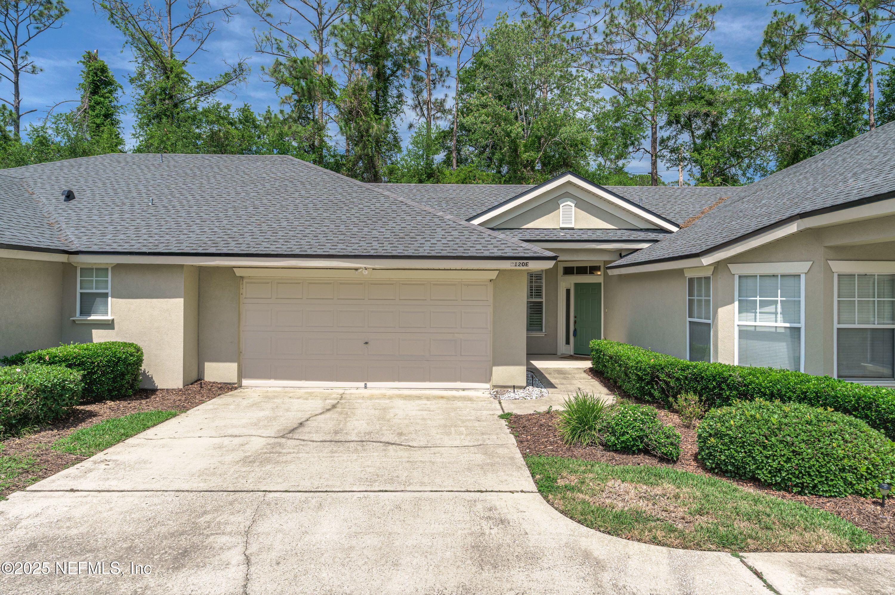 2120 Stone Creek Drive, Unit E Fleming Island, FL 32003 - Photo 30 of 66 a front view of a house with a garden