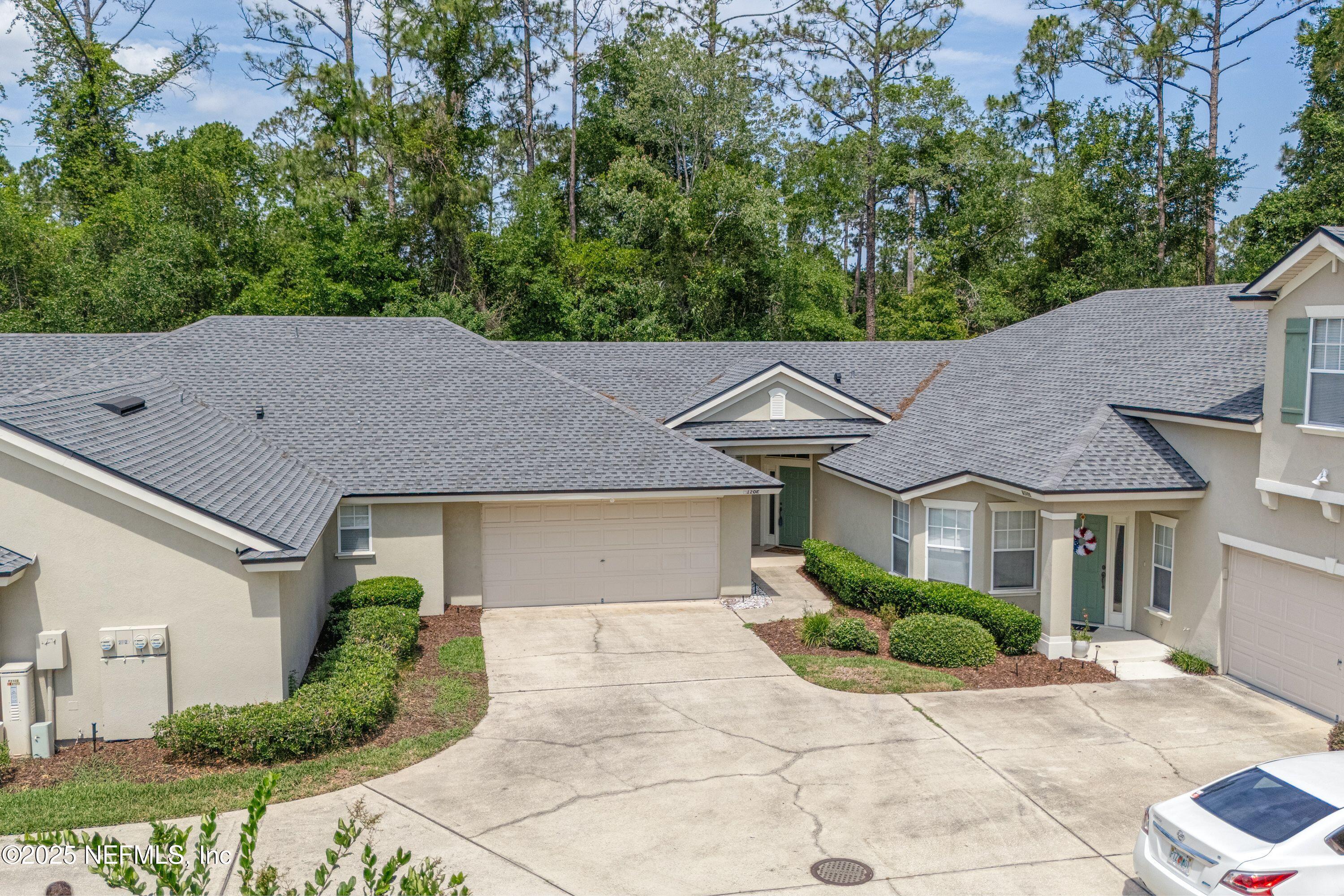 2120 Stone Creek Drive, Unit E Fleming Island, FL 32003 - Photo 31 of 66 a aerial view of a house with a yard and large tree
